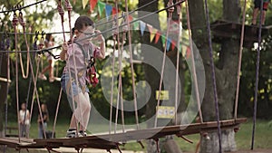 Little boy on a rope bridge