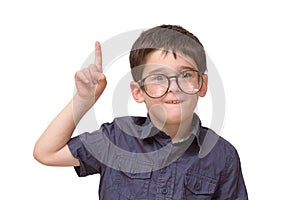 Little boy in round spectacles raising finger photo