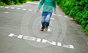 Little boy run on footpath to the finish line