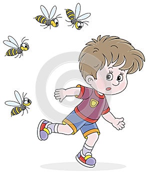 Little boy running away from angry wasps