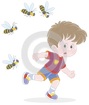 Little boy running away from angry wasps