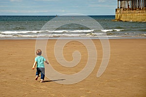 Little boy running on the beach