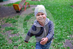 Little boy running down a dirtpath in a beautiful landscape in summer,