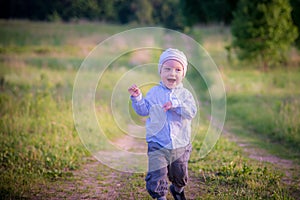 Little boy running in a field