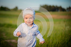 Little boy running in a field