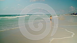 Little boy is running playing with seagulls on the beach. Boy and seagulls. Panama City Beach