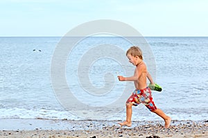 Little boy running at the seashore