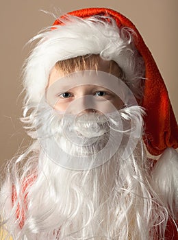 Little boy in Santa Claus suit with beard