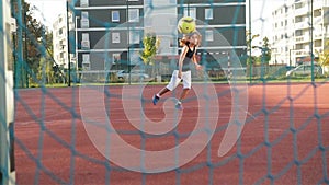 A little boy scores a goal kicks ball. He has a lot of fun playing soccer outdoors.