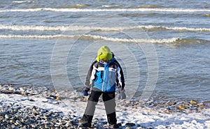 Little boy at the sea coast dreaming of the summer