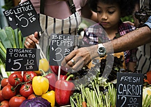 Little Boy Selling Vegetable at Market photo