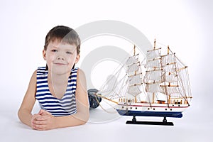 Little boy with ship on white
