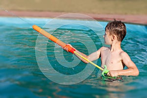 Little boy shoot with water cannon