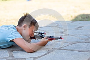 Little boy shooting with suction cup toy