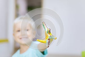 Little boy showing a dirty hand with paint