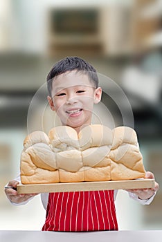 Little boy showing his bread