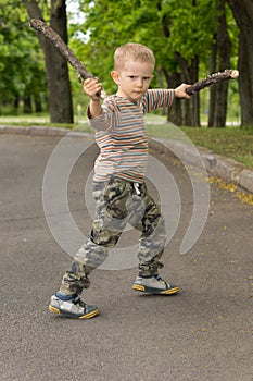 Little boy showing off his stick fighting skills