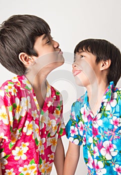 Little boy sibling boy in Thai flower dress tradition for Thai new year