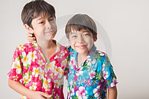 Little boy sibling boy in Thai flower dress tradition for Thai new year