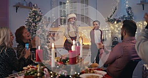 Adorable children performing poems on Christmas dinner with family photo