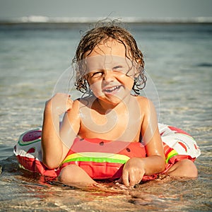 Little boy sitting on the beach