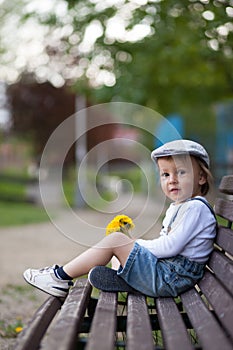 Little boy, sitting on a bench