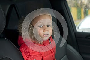 Little boy is sitting in the car