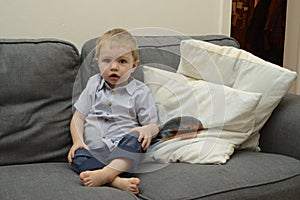 Little boy sitting on couch