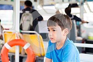 Little boy sitting in ferry cross over the river