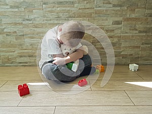 Little sad boy sitting on the floor tenderness unhappy a block depression frustratedsadness