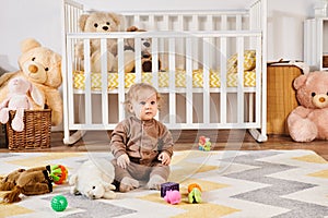 little boy sitting on floor near