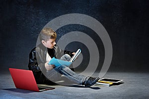 Little boy sitting with gadgets