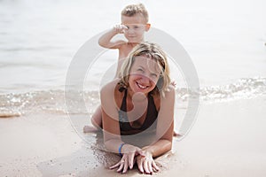 Little boy sitting on mother's back