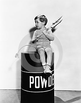 Little boy sitting on powder keg