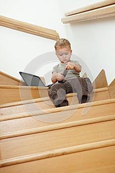 Little boy sitting on stairs
