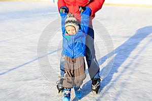 Little boy skating with parent