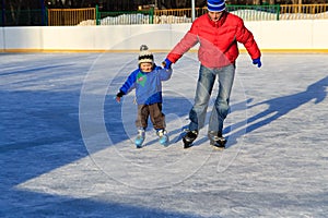 Little boy skating with parent