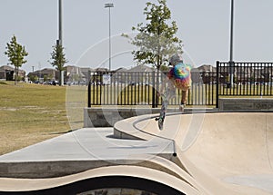 A little boy skating at Skate Park