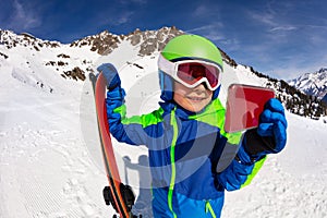 Little boy with ski video call holding smartphone