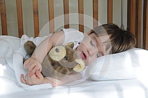 Little boy sleeping with teddy bear