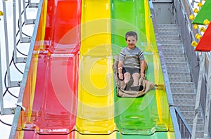 Little boy on a slippery slide