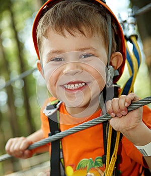 Little boy smiling in adventure park