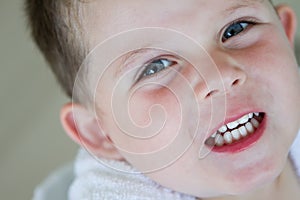 Little boy smiling wearing his bath robe