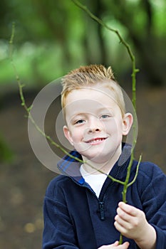 Little boy smiling in the woods