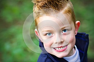 Little boy smiling in the woods