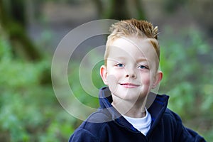 Little boy smiling in the woods