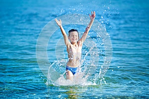 Little boy with snorkel by the sea. Cute little kid wearing mask and flippers for diving at sand tropical beach. Ocean coast