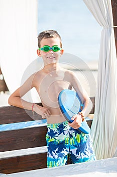 Little boy with snorkel by the sea. Cute little kid wearing mask and flippers for diving at sand tropical beach. Ocean coast