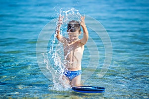 Little boy with snorkel by the sea. Cute little kid wearing mask and flippers for diving at sand tropical beach. Ocean coast