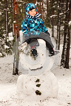 Little boy and snowman